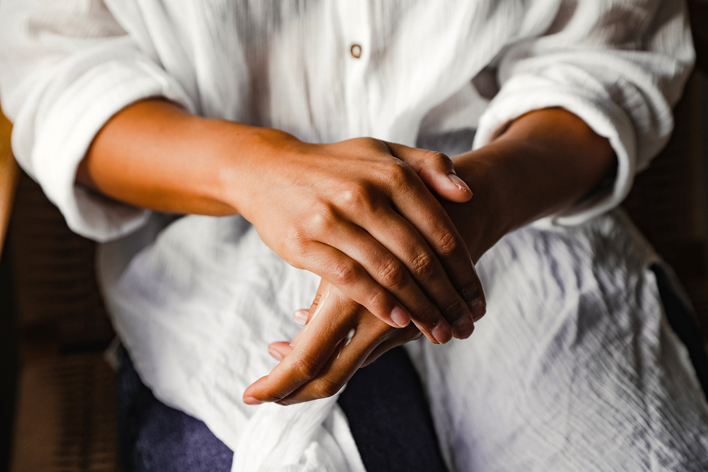 Close-up of hands rubbing in soothing balm.