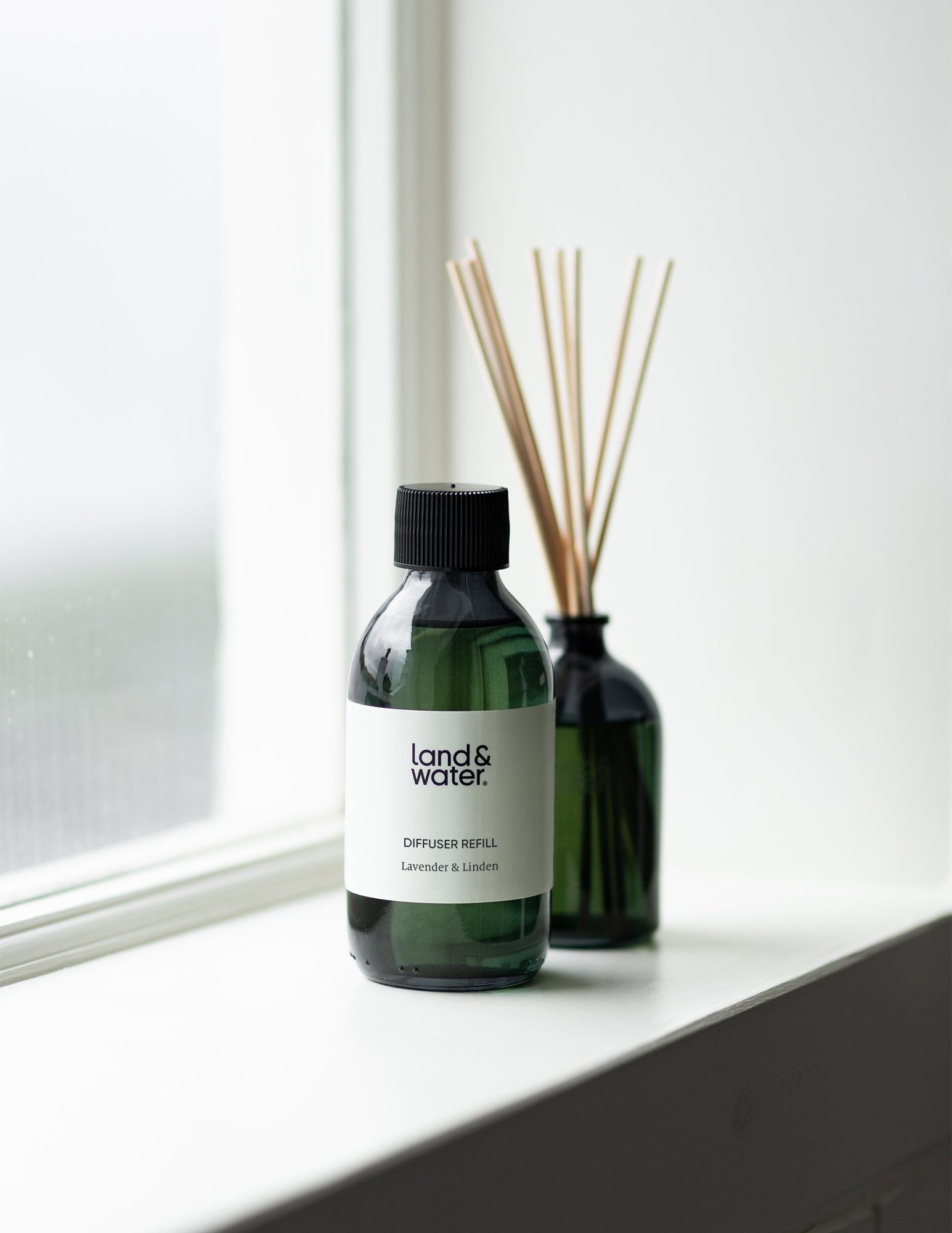 Reed diffuser refill and reed diffuser on a windowsill