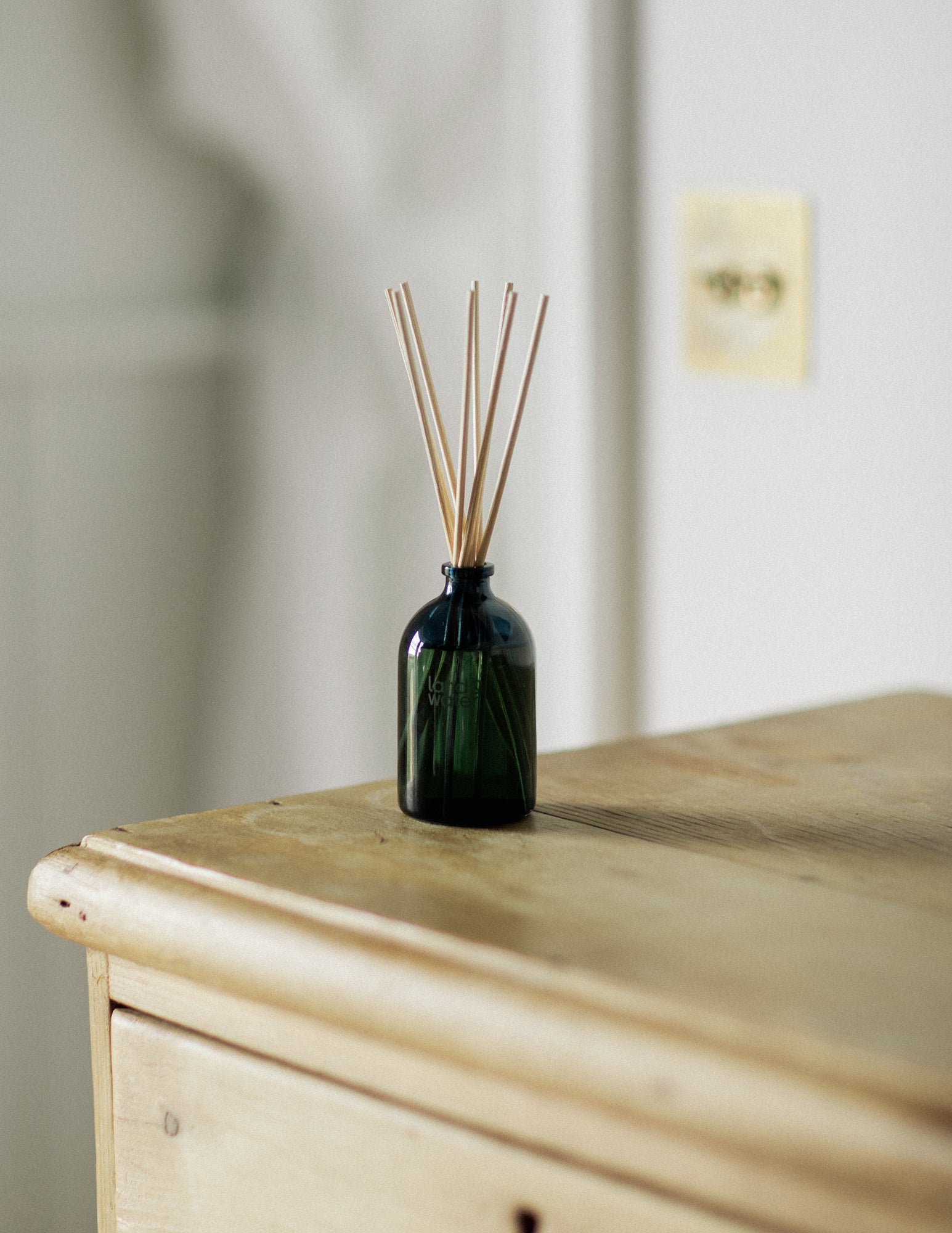 Reed Diffuser on wooden chest of drawers