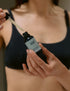 woman using daily serum with pipette bottle