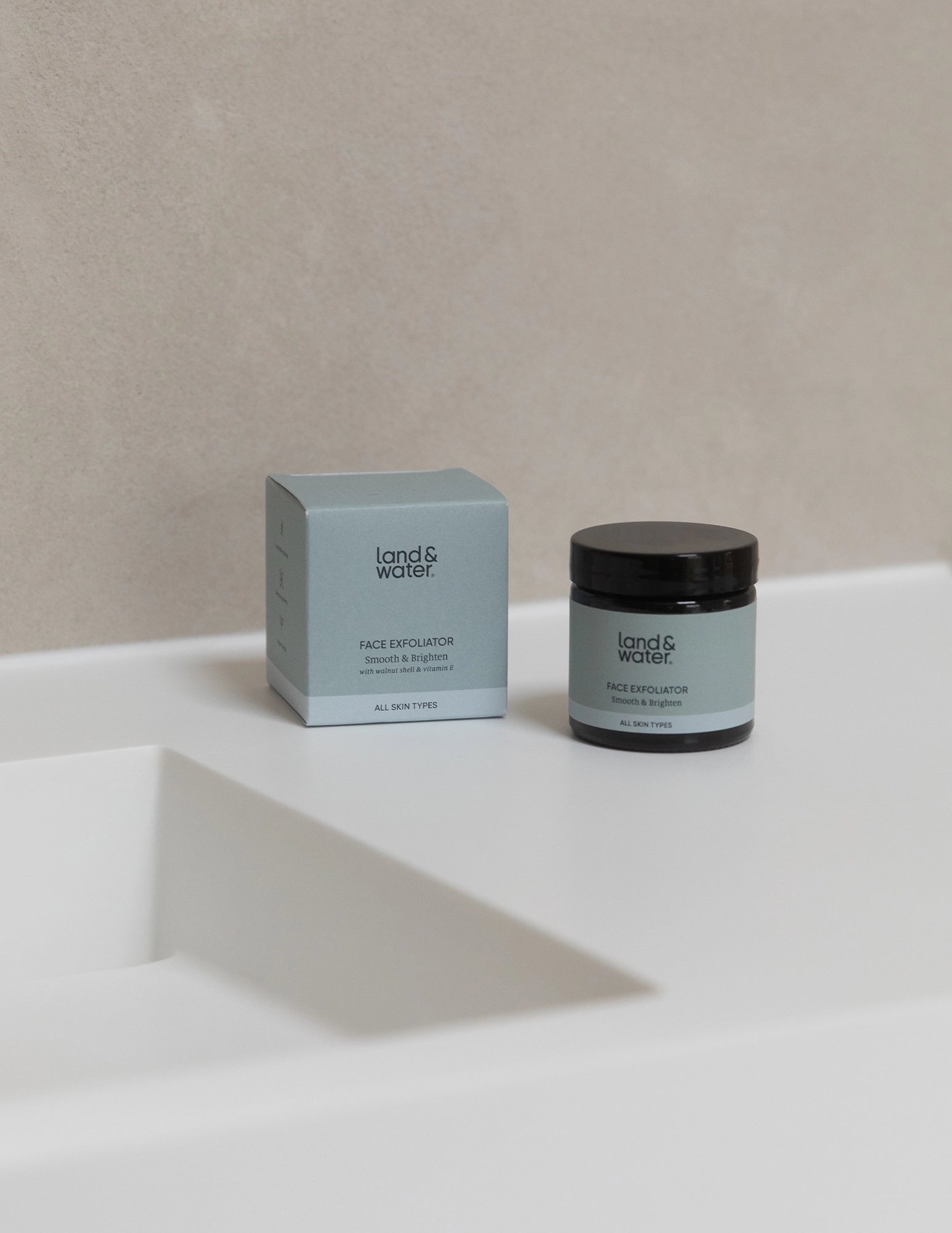Face Exfoliator jar and box by a sink
