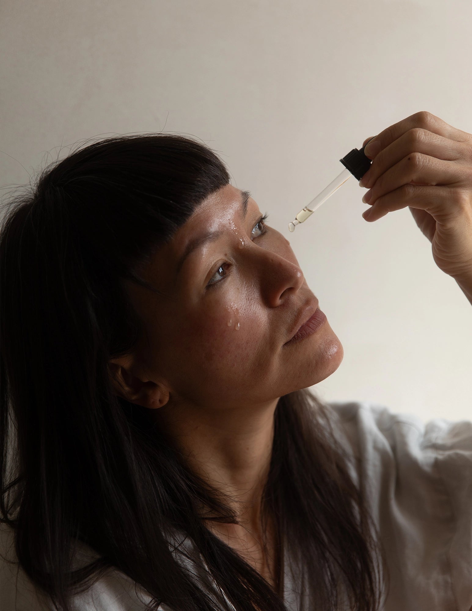 woman applying face oil