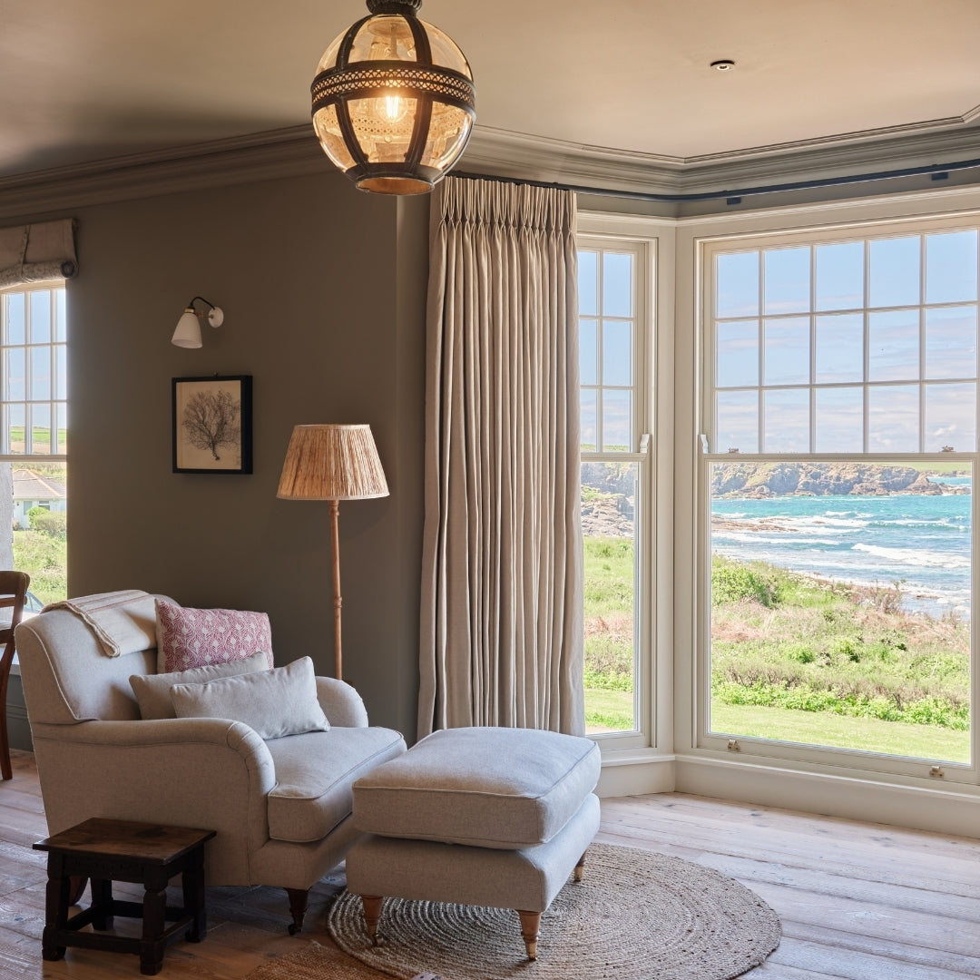 A room at Atlanta Trevone with an armchair with a window which looks out looks out to the sea