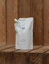 1 litre body lotion refill pouch on wooden shelf