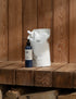 1 litre hand lotion refill pouch and 250ml body lotion bottle on wooden bench