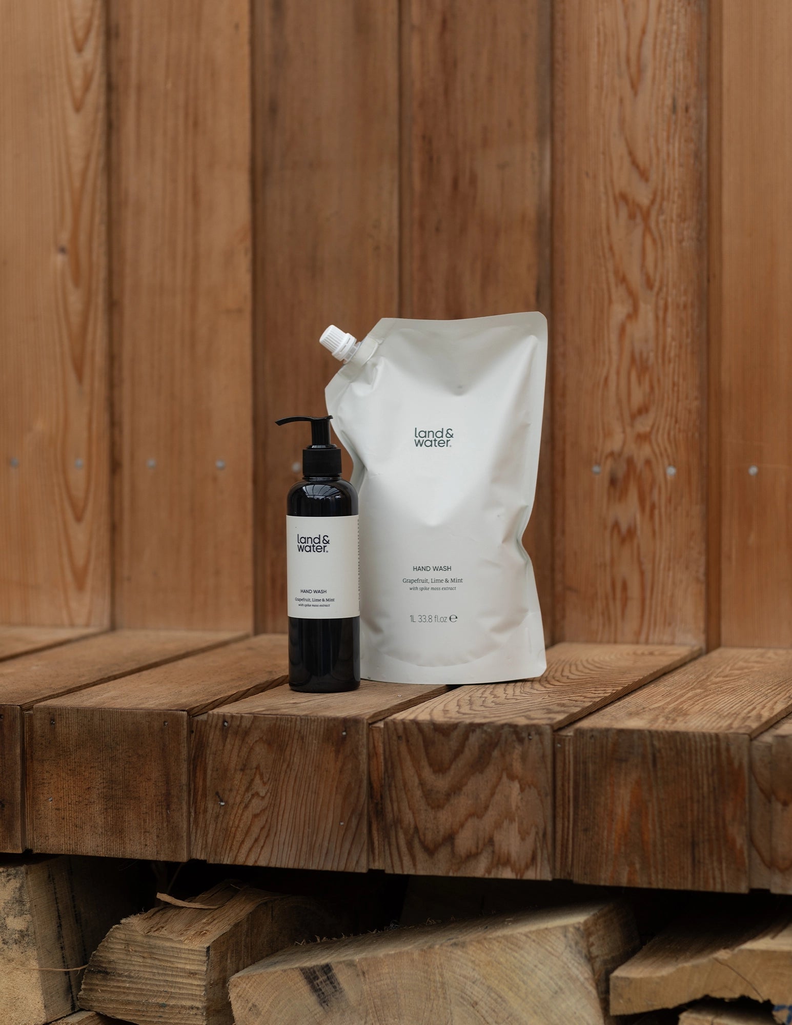 1 litre hand wash refill pouch and 250ml bottle hand wash on wooden bench