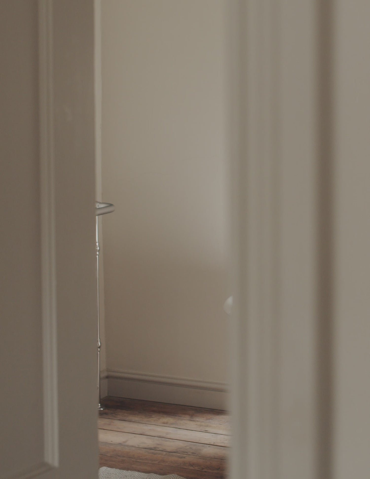 A short film clip showing a woman wrapped in a towel sprinkling bath salts into the bath and then stepping in.