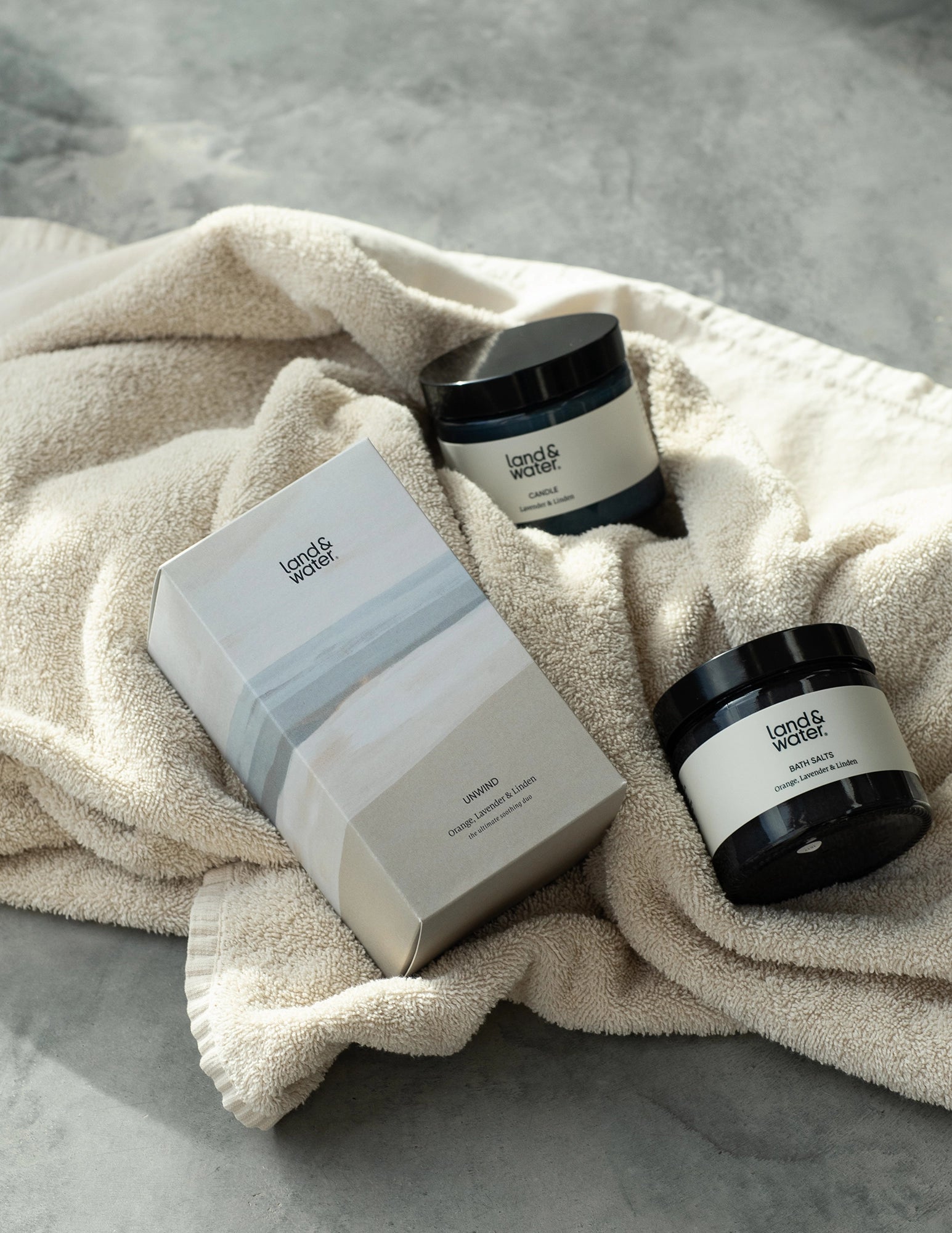Candle and Bath Salts and gift box on a towel