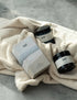 Candle and Bath Salts and gift box on a towel
