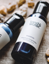 mini shampoo (50ml) lying on hessian mat alongside another 50ml land&water product