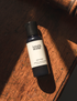 A 50ml travel size bottle of body wash from the brand &