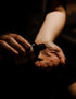 A person pouring some land&water Bath & Body Oil onto their hand