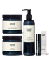 A collection of natural bath and body products including a candle, bath salts, pulse point oil, and body lotion.