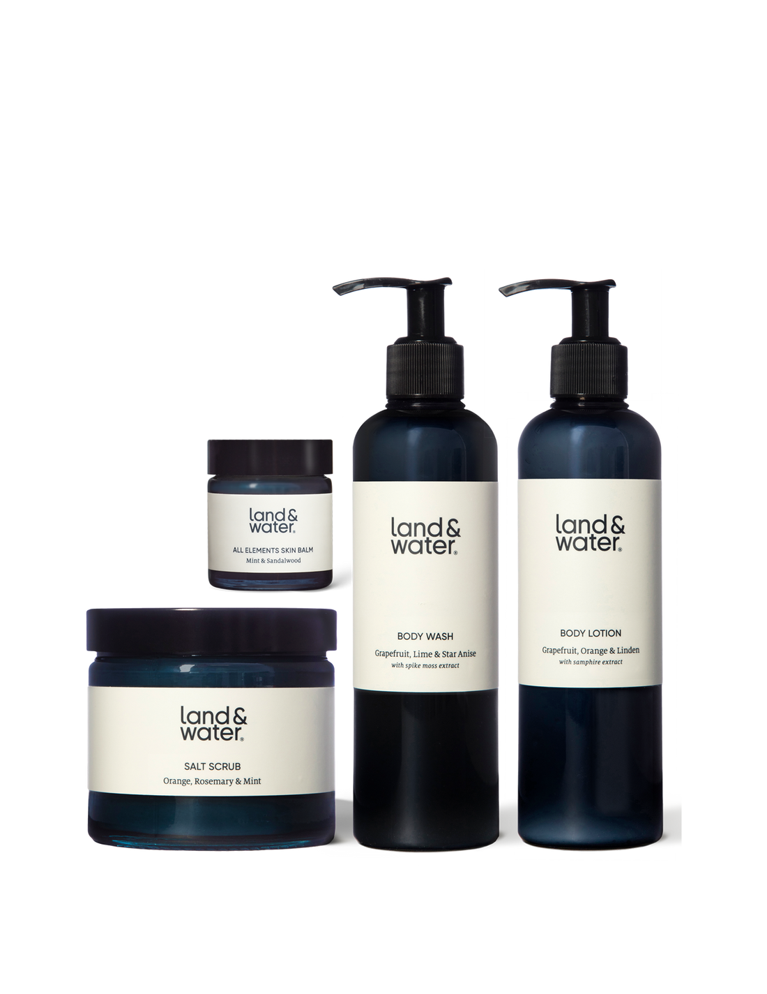 A collection of bath and body products from land&water, including a body wash, body lotion, salt scrub, and skin balm, displayed against a white background.