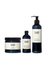 A Mandarin & Mint scented candle next to a bottle of bath and body oil and a body lotion. These items make up the &