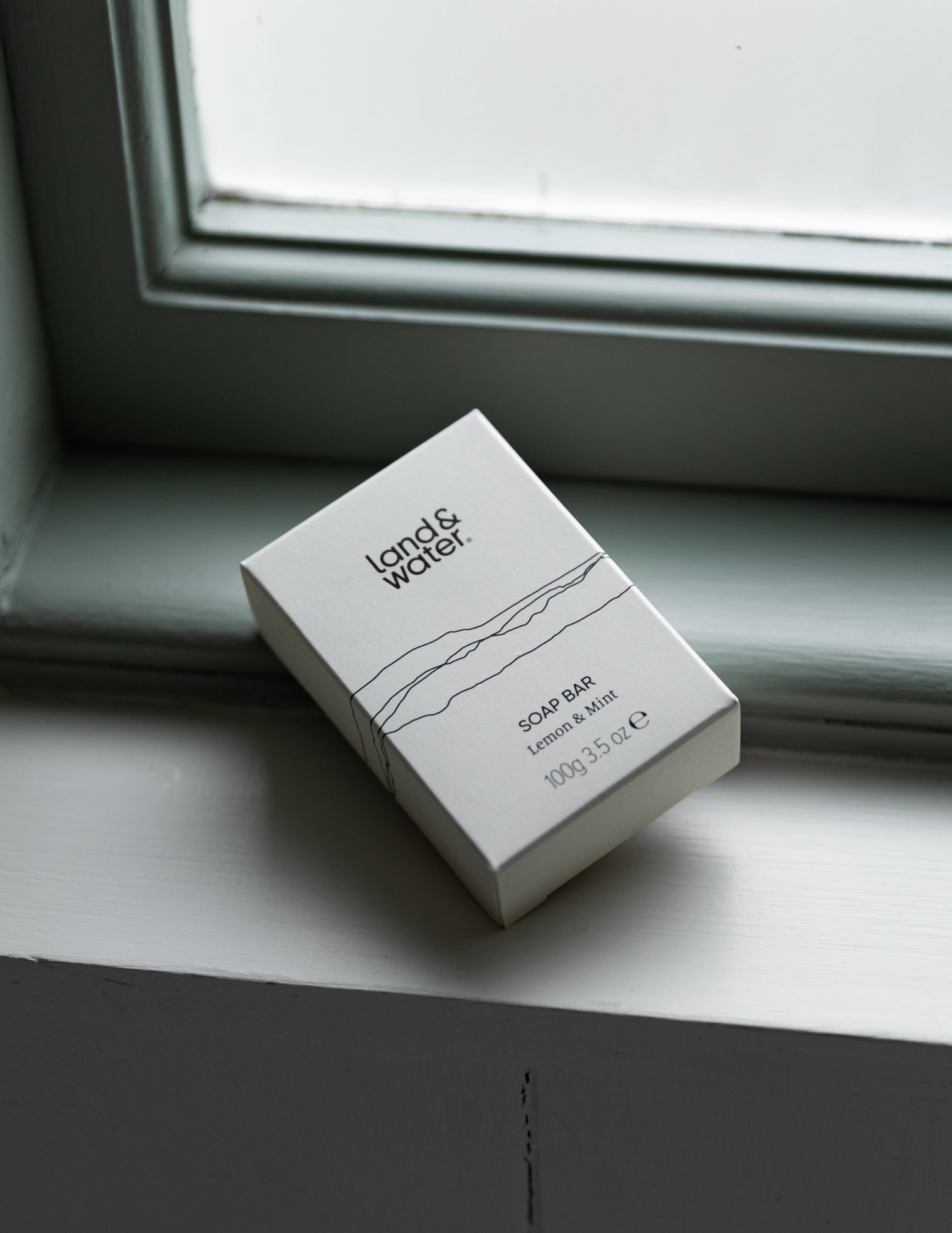 100g soap bar in a printed box on a window sill