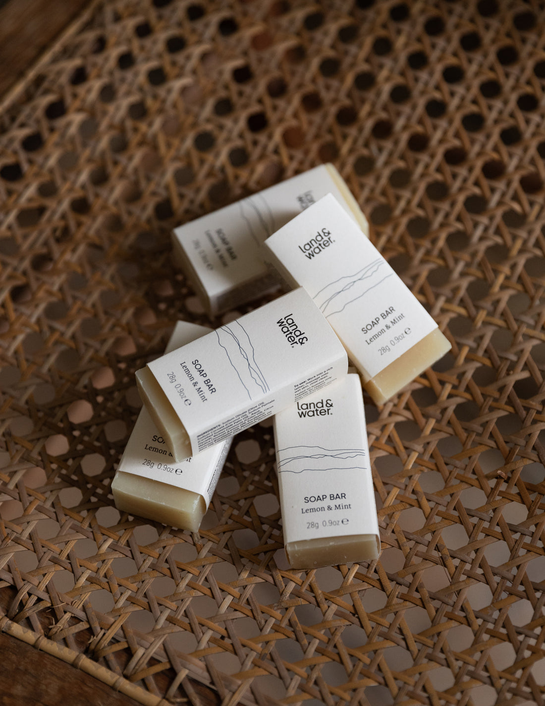 mini soap bars loosely stacked on a wicker chair