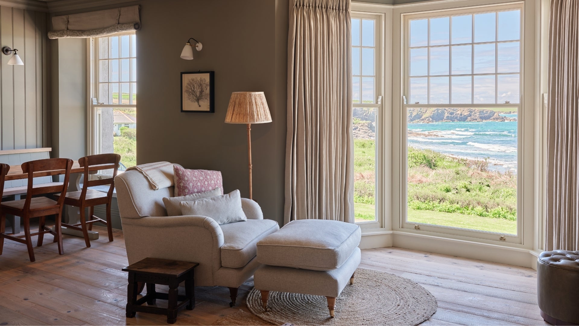 A room at Atlanta Trevone with an armchair with a window which looks out looks out to the sea