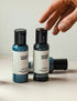 Two travel-sized bottles of body wash and lotion. A person&